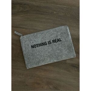 Slnghr Zip Clutch Bag Nothing Is Real